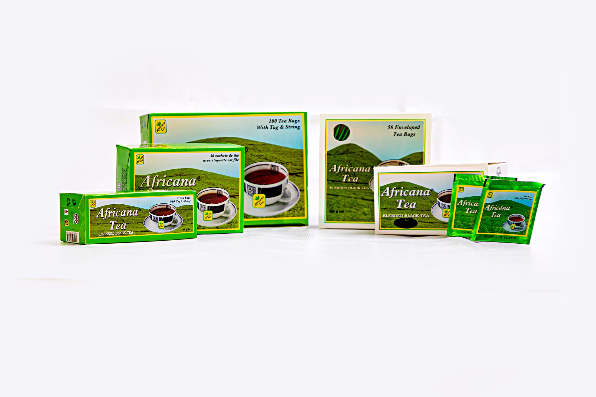 Africana Tea Bags — green hills design across tagged tea bag boxes, enveloped box, and individual sachets